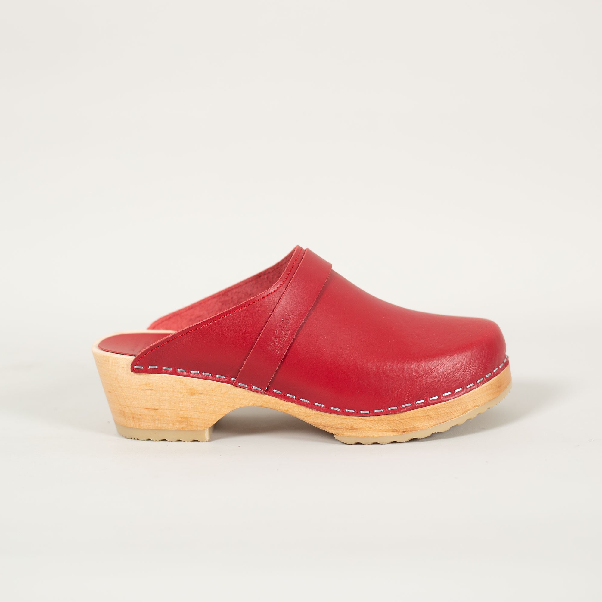 Berkeley clogs in red leather on a natural wooden bottom