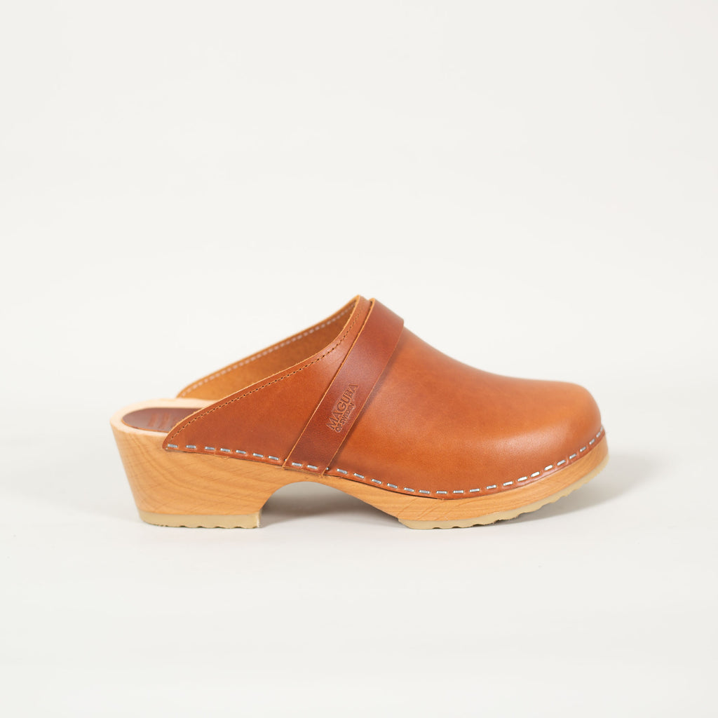 Berkeley clogs in cognac pull up leather on a natural wooden bottom